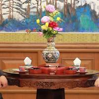 Chinese President Xi Jinping (right) meets with North Korean leader Kim Jong Un at the Diaoyutai State Guesthouse in Beijing June 20. U.S. to give North Korea post-summit schedule with 'specific asks' soon: official