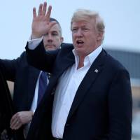 U.S. President Donald Trump speaks to reporters as he arrives aboard Air Force One from Singapore at Joint Base Andrews in Maryland on Wednesday. 'Mission Accomplished' moment: Trump's North Korea no longer nuke threat claim raises eyebrows