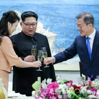 South Korean President Moon Jae-in toasts with North Korean leader Kim Jong Un and his wife, Ri Sol Ju, during a banquet at the border village of Panmunjom in the Demilitarized Zone on April 27. Architects of South Korea's Sunshine Policy on North say it's paying off