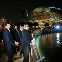 North Korean leader Kim Jong Un looks out from the Jubilee Bridge during a tour in Singapore on Monday. Verification key to gauging Kim's commitment to denuclearization
