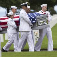 U.S. Navy personnel carry the casket of WWII U.S. Navy sailor Julius Pieper during a reburial service at the Normandy American Cemetery, Colleville-sur-Mer, France, Tuesday. Seventy four years to the day after their ship hit a mine off the coast of Normandy and sank, Julius Pieper was finally reunited with his twin brother, Ludwig. Twin brothers reunited 74 years after WWII death at Normandy