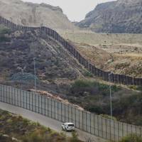 A border patrol car drives past the old border wall in San Ysidro, California, on June 4, 2018. The Trump administration has failed to kill a legal challenge to its practice of separating undocumented parents and children entering the U.S. to flee persecution at home. U.S. judge slams Trump administration practice of separating children from parents seeking asylum