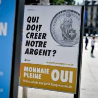 This photograph, taken in Geneva on May 24, shows an electoral poster in favor of a “sovereign money” initiative. It reads, in French: ‘Who should create our money?’ Swiss voters Sunday cast ballots for the “sovereign money” initiative, which, if it passes, will legally bar any institution other than the central bank from creating new money. Swiss 'real money' initiative fails after lack of support from cantons