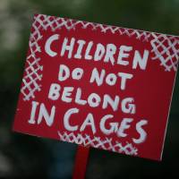A sign criticizing the Trump administration policy of separating immigrant families suspected of illegal entry is seen during a protest in New York on Tuesday. Trump administration sending babies and young children forcibly separated from parents at border to 'tender age' shelters