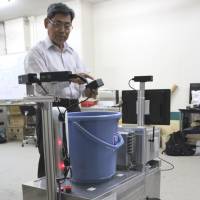 A self-driving, handcart-type robot, being developed to support farmers who grow flowers, is seen at Toyohashi University of Technology in Toyohashi, Aichi Prefecture. Aichi team develops self-driving robots to tackle labor shortage in farming