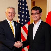 Foreign Minister Taro Kono greets U.S. Secretary of Defense James Mattis before talks in Tokyo on Friday. Japan bothered by ramifications of U.S. halt to Korean war games