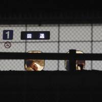 Passengers are seen Saturday evening on a shinkansen that stopped at Odawara Station following a stabbing incident Saturday evening that left one man dead and two women injured. Alleged shinkansen stabber handed to prosecutors after deadly attack