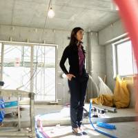 Build it and they will come: A former real estate analyst stands inside her planned Airbnb condominium under construction in Tokyo in January 2016. Implementation of minpaku laws lambasted