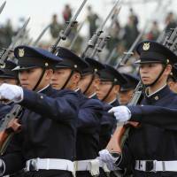 Ground Self-Defense Force personnel march in a parade Oct. 24, 2010. Under the Abe administration, Japan has been beefing up its defense capabilities as regional tensions rise. Who will be Japan's next chief antagonist?