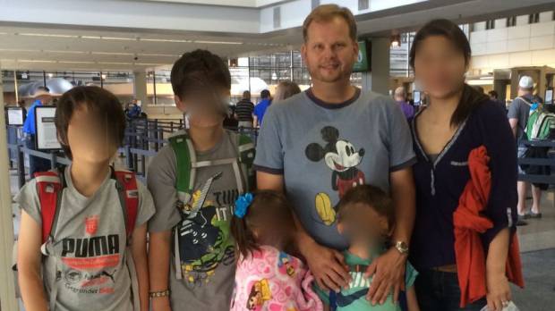Long legal battle: James Cook is pictured with his estranged wife and their two pairs of twins. Left-behind dad's last resort: Impeach Japan's Supreme Court judges
