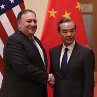 U.S. Secretary of State Mike Pompeo (left) shown with Chinese Foreign Minister Wang Yi in Beijing on June 14, expressed U.S. concerns over China’s militarization of its island holdings in the South China Sea during a visit that centered on North Korean issues. Trump is losing the South China Sea