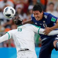 Japan defender Gen Shoji (right) competes with Senegal’s M’Baye Niang during their World Cup match on Sunday in Yekaterinburg, Russia. Japan's conviction growing stronger with each step at World Cup