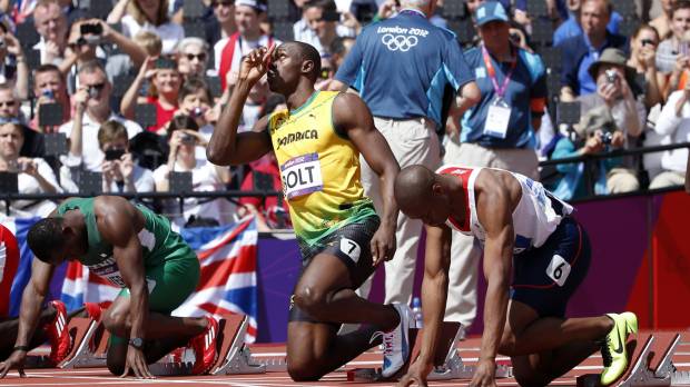 Jamaica’s Usain Bolt (center) is seen before competing in a men’s 100-meter heat at the 2012 London Olympics. Pair of signed Usain Bolt spikes from 2012 London Games stolen
