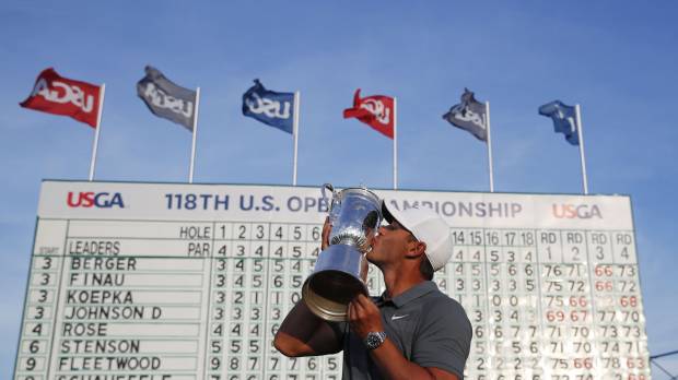 Brooks Koepka kisses the trophy after winning the U.S. Open for the second straight year on Sunday in Southampton, New York. Brooks Koepka repeats as U.S. Open champion