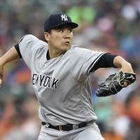 Masahiro Tanaka pitches against the Orioles during the first inning on Saturday in Baltimore. Masahiro Tanaka strikes out seven as Yankees beat Orioles