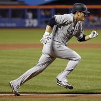 Yankees pitcher Masahiro Tanaka runs home to score on a sacrifice fly against the Mets during the sixth inning on Friday in New York. Yankees' Masahiro Tanaka joins three other Japanese pitchers on DL