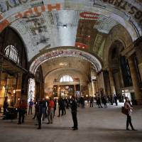 Attendees view the interior of Michigan Central Station during a Ford Motor Co. event in the Corktown neighborhood of Detroit on June 19. Five years after declaring bankruptcy, Detroit boasts rebirth — but at a cost
