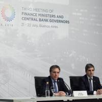 Luis Caputo (right), president of the Argentine central bank, and Argentine Treasury Minister Nicolas Dujovne, listen to a question at a news conference during the Group of 20 finance ministers and central bankers’ meetings in Buenos Aires on Sunday. G20 finance leaders say increased trade and geopolitical tensions could affect global growth