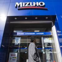 People walk past a Mizuho Bank branch in the Shibuya district of Tokyo. Mizuho Financial Group Inc.’s trust banking arm has its sights set on trillions of yen held by the nation’s elderly. Mizuho's trust banking sector sets sights on $11 trillion held by Japan's well-heeled elderly