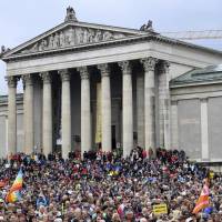 Protestors attend a demonstration under the slogan ‘United Against Politics Of Fear’ in Munich, Germany, Sunday. 25,000 protest immigration stance of Merkel's Bavarian allies, slam 'politics of fear' and shift to right
