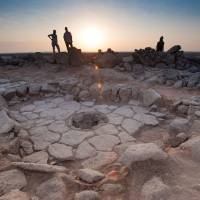 A stone structure at an archeological site containing a fireplace, seen in the middle, where charred remains of 14,500-year-old bread was found in the Black Desert, in northeastern Jordan. World's oldest bread found in Jordan