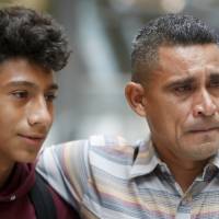 Edvin Cazun (right), of Guatemala, hugs his son, Samuel, at Cincinnati/Northern Kentucky International Airport as they reunite after being separated about a month ago at the southern border after they crossed the Rio Grande into the United States, Monday in Hebron, Kentucky. Edvin said they were separated at the “detention” and he spent 15 days without knowing anything about his son. U.S. urges judge to allow fast deportations of reunited migrant families in snub to ACLU