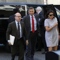 Michael Flynn (center), former U.S. national security adviser, arrives for a status hearing at federal court in Washington on Tuesday. Flynn made his first federal court appearance since pleading guilty last year to lying to federal agents, appearing briefly before a judge who asked to be updated on the status of the case by Aug. 24. Michael Flynn said 'eager' for sentencing over lying to FBI but Robert Mueller wins delay amid Russia probe