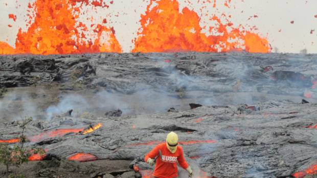 A geologist collects a sample of molten lava from the Kamoamoa eruption at Hawaii’s Kilauea volcano in March 2011. Scientists defy 'force of nature' to unlock secrets of Hawaii volcano