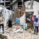 Palestinian artists display artwork in the yard of the damaged Arts an d Crafts Village, which was hit by Israeli airstrikes two days before, in Gaza City on Monday.