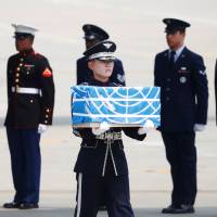 A soldier carries a casket containing the remains of a U.S. soldier who was killed in the Korean War during a ceremony on Friday at Osan Air Base in Pyeongtaek, South Korea. North Korea hands over remains of U.S. war dead on 65th anniversary of Korean War armistice
