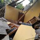  An Indonesian stalls in the ruins of a house on the following Sunday in an earthquake in Lombok. 