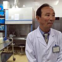 Doctor O Yong Il explains how patients are diagnosed at the National Tuberculosis Reference Laboratory in Pyongyang on May 7. Despite detente, sanctions on North Korea fan TB epidemic