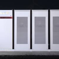 Tesla Inc. Powerpacks that will be used to form the world’s largest lithium-ion battery stand on display at the Hornsdale wind farm near Jamestown, South Australia, on Sept. 29, 2017. Silicon Valley may be powered using giant lithium-ion batteries under new projects to switch away from fossil fuels