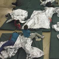 People who have been taken into custody related to cases of illegal entry into the United States rest in one of the cages at a facility in McAllen, Texas, June 17. Teens taken at U.S. border tell of crammed 'icebox' and 'kennel' cages