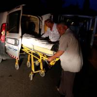 Hospital workers transport the body of a Tunisian security force member, who was killed in an ambush in the northwest of the country close to the border with Algeria, at a hospital morgue in Tunis Sunday. 'Terrorist attack' kills six Tunisia security force ranks in restive border area