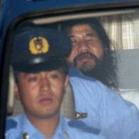 In this August 1995 file photo, Shoko Asahara, leader of the Aum Shinrikyo cult, is seen being driven away from the Tokyo District Court to the Metropolitan Police headquarters after an extension of his detention was approved. The doomsday cult that carried out a deadly nerve gas attack on Tokyo’s subways the same year also used the VX nerve agent suspected in the killing of North Korean leader Kim Jong Un’s half-brother. A chronology of doomsday cult and its founder