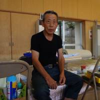 Landslide evacuee Shigenobu Ikeda seeks refuge at an elementary school in Aki Ward, Hiroshima, that is being used as an evacuation center. Traumatic memories and concerns for the future unnerve those displaced by Hiroshima rain disaster