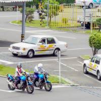 Drivers-to-be practice at Yokohama Driving School in Totsuka Ward in the city on June 22. The school is one of the remaining 1,300 authorized driving schools nationwide as the sector faces the effects of demographic change in the nation. Japan's driving schools, squeezed by demographic change, target foreign residents to stay afloat