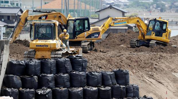 Workers conduct repair work on the destroyed embankment along Odagawa River in the Mabicho district of Kurashiki, Okayama Prefecture, on Friday. More in LDP call for surge in public works after disasters, but some see election ploy