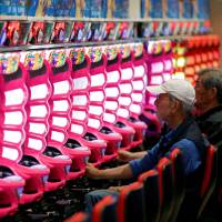 People play pachinko in the city of Fukushima in May. Already in decline, Japan's pachinko industry now braces for gambling-addiction regulations