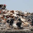 Household waste collected in the wake of the heavy flooding in western Japan is piled up at a temporary collection site in Kurashiki, Okayama Prefecture, on Saturday.