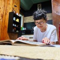 The written word: Yuyushi Furuta studies at her home in Tokyo, which is filled with items that help with her calligraphy. Of the many items in a calligrapher's toolbox, the most important are words