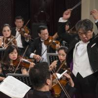 The maestro: Tetsuji Honna conducts the Vietnam National Symphony Orchestra during a performance at the Hanoi Opera House on 26 Oct. 2017. Tetsuji Honna picks up the tempo in Hanoi