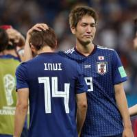 Dejected: Japan’s Genki Haraguchi consoles Takashi Inui after the team was knocked out of the World Cup by Belgium in the cruelest of ways in Rostov-on-Don, Russia, on July 2. 'All Japan' World Cup team gave fans and the media much to mull over