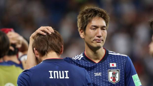 Dejected: Japan’s Genki Haraguchi consoles Takashi Inui after the team was knocked out of the World Cup by Belgium in the cruelest of ways in Rostov-on-Don, Russia, on July 2. 'All Japan' World Cup team gave fans and the media much to mull over