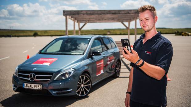A Bosch employee uses a smartphone app to remotely park a car in Germany last July. Bosch is now building a €1 billion semiconductor plant as it prepares for a surge in demand for components used in self-driving vehicles. Japan automakers' dominance is fading