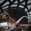 Workers stand on a boom lift inside a terminal under construction at Beijing� 39;s new international airport July 6, 2018. The new airport is scheduled to begin operations next year.