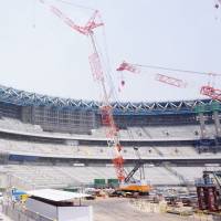 Media members tour the site of the new National Stadium on Wednesday. Progress on new National Stadium going as planned
