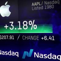 An electronic screen displays the Apple Inc. stock price at the Nasdaq Market Site in New York City Thursday. Apple becomes first private-sector company to reach landmark $1 trillion valuation