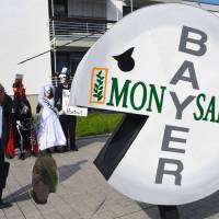 A protester wears a pill-shaped costume bearing the names of Bayer and Monsanto during a demonstration against the takeover of U.S. seeds and pesticides maker Monsanto by German chemicals firm Bayer outside the World Conference Center, where the annual general meeting of chemicals giant Bayer took place in Bonn, western Germany, in May. A cancer victim’s surprise court victory over U.S. pesticide maker Monsanto could open the floodgates to a slew of similar lawsuits, potentially leaving the firm’s new German owner Bayer with a major case of buyer’s remorse. $289 million Roundup cancer verdict sends Bayer shares reeling